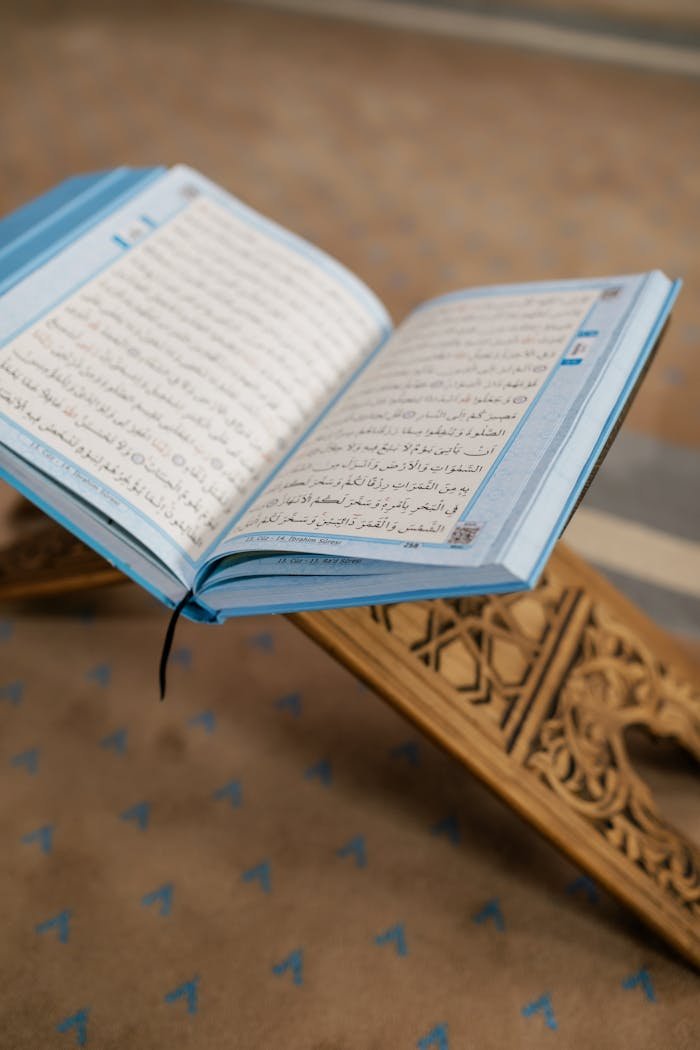 pexels-photo-8164515 Open Quran on a wooden stand inside a mosque, symbolizing Islamic faith.